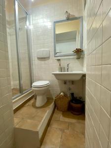 a bathroom with a toilet and a sink at Appartamento La Corte di Trevi in Trevi +39 photos