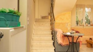 a spiral staircase in a room with a table at Evelyn's House in Artemida
