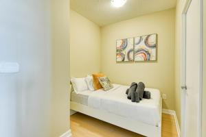a bedroom with a bed with white sheets at RivetStays - The Parade 2 in Toronto