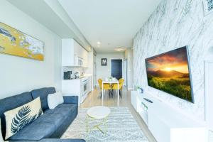 a living room with a couch and a table at RivetStays - The Parade 2 in Toronto