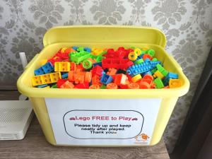 a yellow tub full of lego toys on a table at Near Legoland - Spacious Home (4BR3B) #Cowidéa in Nusajaya