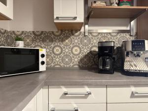 a kitchen counter with a microwave and a coffee maker at Bungalow no 9 in Dorsten