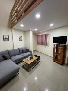 a living room with a couch and a flat screen tv at Saranda View Apartments in Sarandë