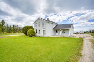 a white house with a green lawn in front of it at Waterfront Lake Michigan Home on 15 Acres! in Manitowoc