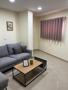a living room with a couch and a coffee table at Saranda View Apartments in Sarandë