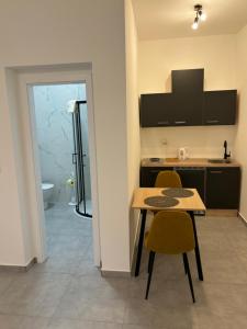 a kitchen with a table and chairs in a room at Apartment JANG in Tolmin