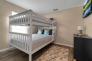 a white bunk bed in a room with a desk at Pool & Play Oasis! All the Amenities & Near AMI! in Bradenton +50 photos