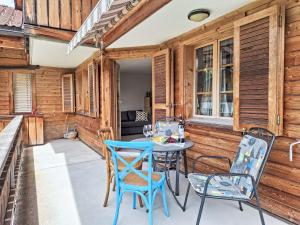 a patio with a table and chairs on it at Apartment Haus Europa by Interhome in Kandersteg