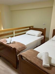 a room with two beds with towels on them at Saranda View Apartments in Sarandë