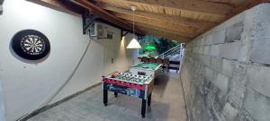 a ping pong table in a room next to a wall at Villa Hedonic in Ulcinj