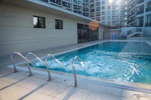 a swimming pool on the side of a building at Skyline 11B Apartment - Sea View,Pools & SPA in Varna City +50 photos