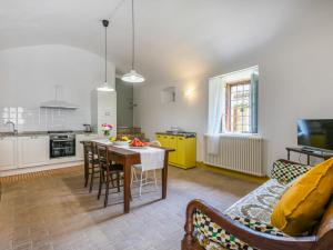 a living room with a table and a kitchen at Apartment La Torre-5 by Interhome in Stigliano