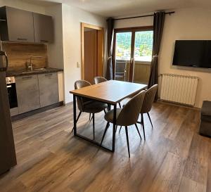 a dining room table and chairs in a kitchen at Appartment Marcher in Kaprun