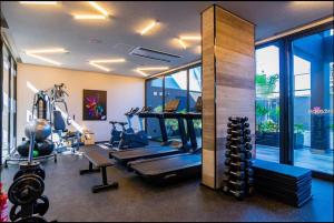 a gym with cardio equipment in a room with windows at Studio On Alvorada Garden 204 - Vila Olímpia in Sao Paulo