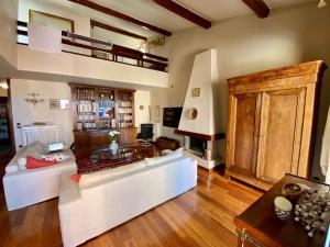 a living room with a white couch and a table at Vistalaguna Orbetello in Orbetello