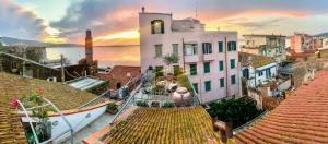 a large white building with a boat on the roof at Vistalaguna Orbetello in Orbetello