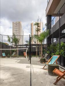 a park with benches and a fence and buildings at Studio On Alvorada Garden 204 - Vila Olímpia in Sao Paulo