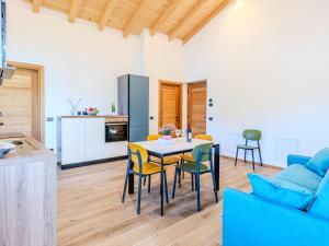 a kitchen and a living room with a table and chairs at Apartment Cigno by Interhome in Verceia +24 photos