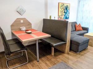 a living room with a table and a couch at Apartment Seestraße 60 by Interhome in Döbriach