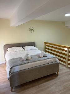 a bedroom with a bed with two towels on it at Saranda View Apartments in Sarandë