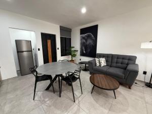 a living room with a couch and a table at Departamento Colima 1 in Colima