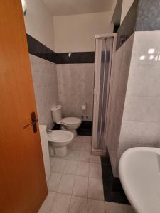 a bathroom with a toilet and a sink at Casa Alessia Taormina in Taormina