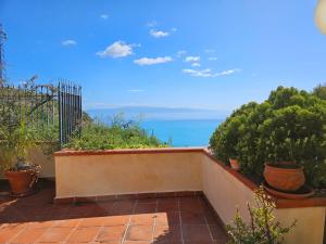 a balcony with plants and a view of the ocean at Casa Alessia Taormina in Taormina