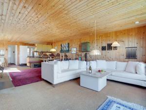 a living room with white furniture and a wooden ceiling at Holiday Home Githe - from the sea by Interhome in Hals