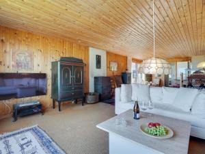 a living room with a couch and a tv at Holiday Home Githe - from the sea by Interhome in Hals