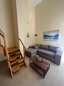 a living room with a couch and a table at Saranda View Apartments in Sarandë