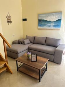 a living room with a couch and a coffee table at Saranda View Apartments in Sarandë