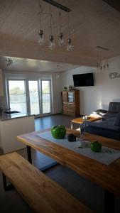 a living room with a table with green bowls on it at Apartment Inge in Rheinhausen +5 photos