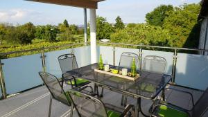 a table and chairs on a balcony with a view at Apartment Inge in Rheinhausen