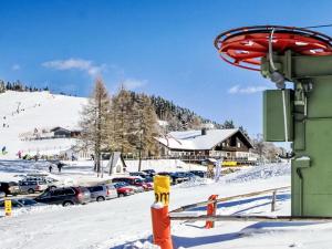 a ski slope with cars parked in the snow at Apartment Maisonette by Interhome in Sankt Paul