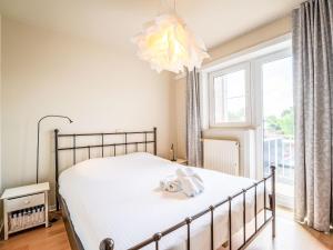 a bedroom with a bed and a large window at Apartment Prima Vera by Interhome in Bredene