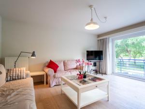 a living room with a couch and a table at Apartment Prima Vera by Interhome in Bredene