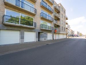 an empty street with two white garage doors on a building at Apartment Prima Vera by Interhome in Bredene