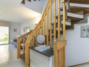 a staircase in a living room with wooden stairs at Holiday Home Xipres by Interhome in Torredembarra +25 photos