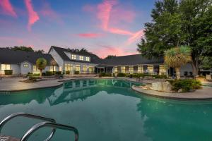 a swimming pool in front of a house at Casa Marigold ATX - Cozy Stay - Near DT & Airport in Austin