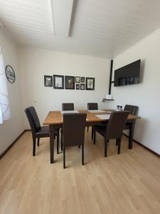 a dining room with a wooden table and chairs at Ferienwohnung Karin in Sankt Jakob im Rosental
