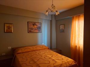 a bedroom with a bed with an orange bedspread at Sea view apartment 2 in Skataj