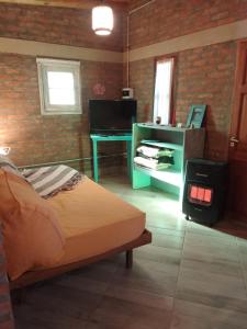 a bedroom with a bed and a desk in a room at El Espinillo in La Falda