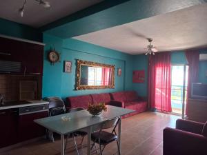 a living room with a couch and a table at Sea view apartment 2 in Skataj