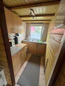 a small kitchen with a sink and a window at Bungalow am Hafen in Dierhagen