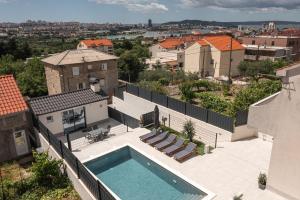 a swimming pool on the roof of a house at Poolhouse Domus in Solin