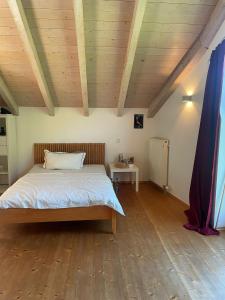a bedroom with a bed and a wooden ceiling at Natur pur! in Nieder-Olm