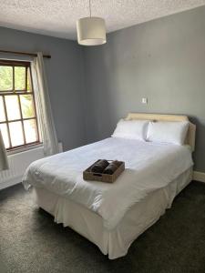 a bedroom with a large bed with a basket on it at Railway Bar Apartment in Poyntz Pass