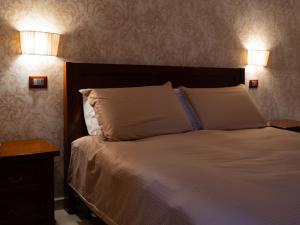 Postel nebo postele na pokoji v ubytování Hotel La Corte di Bacco