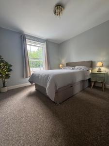 a bedroom with a large bed and a window at Town centre abode with gated parking in Shrewsbury