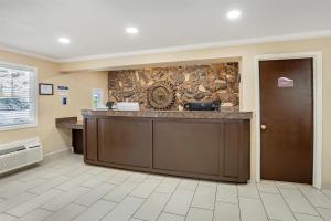 a kitchen with a stone wall and a counter at Best Western Gold Country Inn in Grass Valley +34 photos